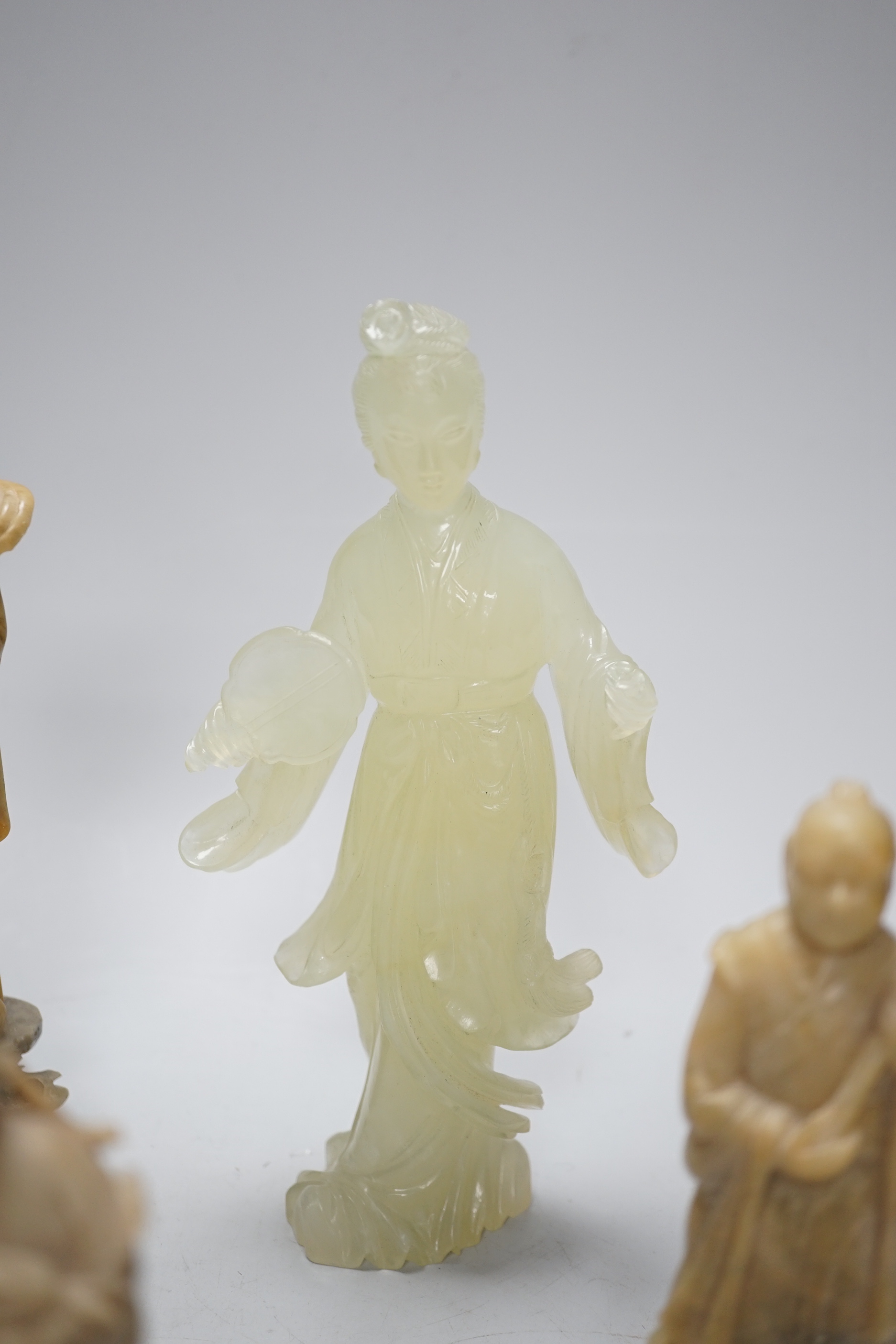 A Chinese bowenite figure and four Chinese carved soapstone figures, the largest 21cm high (5)